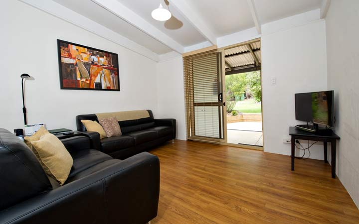 Open plan living area with view overlooking lawned area and gardens